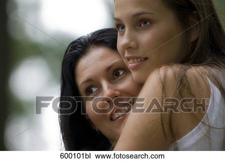 portrait of mother and teenage daughter in close embrace View Large Photo Image Stock Image - portrait of mother and teenage daughter in close embrace. Fotosearch