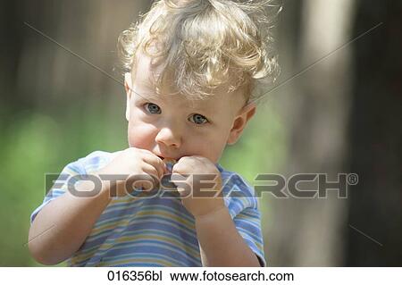 Stock Image - portrait of shy blond child. Fotosearch
