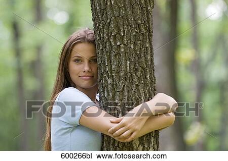 portrait of teenage girl hugging tree View Large Photo Image Stock Image - portrait of teenage girl hugging tree. Fotosearch