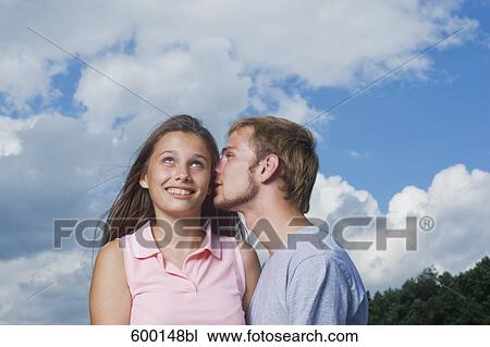 portrait of teenage girl kissed by boyfriend on the cheek View Large Photo Image Stock Image - portrait of teenage girl kissed by boyfriend on the cheek. Fotosearch