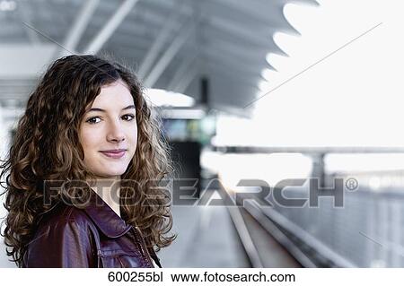 Stock Image - portrait of teenage girl waiting at station. Fotosearch