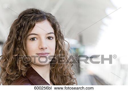 Stock Image - portrait of teenage girl waiting at station. Fotosearch