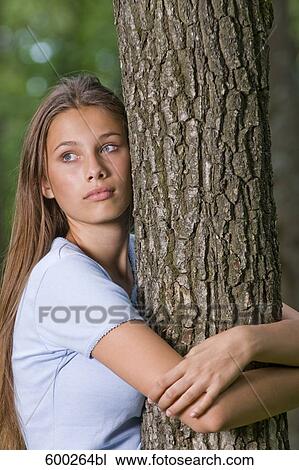 portrait of worried teenage girl hugging tree View Large Photo Image Stock Image - portrait of worried teenage girl hugging tree. Fotosearch