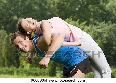 Stock Image - portrait of young couple doing fitness exercises together. Fotosearch