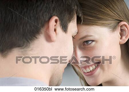 Stock Image - portrait of young couple tenderly looking at each other. Fotosearch