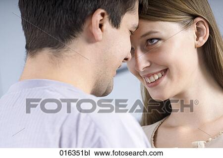portrait of young couple tenderly looking at each other View Large Photo Image Stock Image - portrait of young couple tenderly looking at each other. Fotosearch