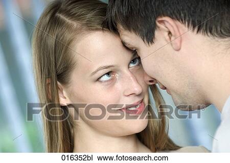 Stock Image - portrait of young couple tenderly looking at each other. Fotosearch