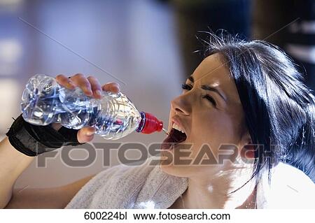 portrait of young female boxer drinking water from plastic bottle View Large Photo Image Stock Image - portrait of young female boxer drinking water from plastic bottle. Fotosearch
