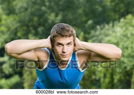 portrait of young man doing exercises in park View Large Photo Image Stock Image - portrait of young man doing exercises in park. Fotosearch