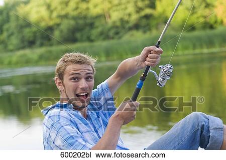 portrait of young man fishing View Large Photo Image Stock Image - portrait of young man fishing. Fotosearch