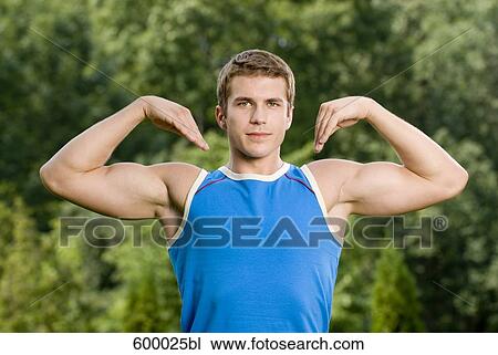 portrait of young man flexing his muscles View Large Photo Image Stock Image - portrait of young man flexing his muscles. Fotosearch