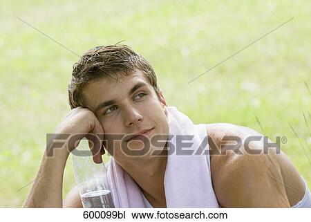 portrait of young man holding water bottle View Large Photo Image Stock Image - portrait of young man holding water bottle. Fotosearch
