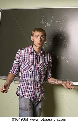 portrait of young student standing in front of blackboard View Large Photo Image Stock Image - portrait of young student standing in front of blackboard. Fotosearch