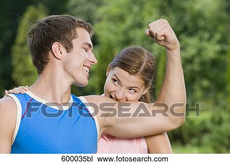 portrait of young woman biting into bicep of boyfriend View Large Photo Image Stock Image - portrait of young woman biting into bicep of boyfriend. Fotosearch
