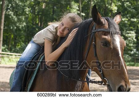portrait of young woman on horse View Large Photo Image Stock Image - portrait of young woman on horse. Fotosearch