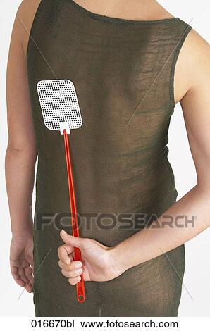 rear view of woman hiding fly swatter behind her back View Large Photo Image Stock Image - rear view of woman hiding fly swatter behind her back. Fotosearch