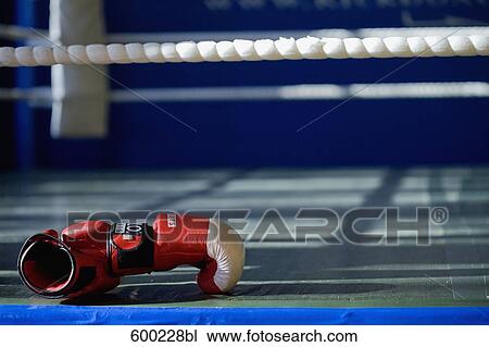 Stock Image - still life of boxing gloves lying ringside at gym . Fotosearch