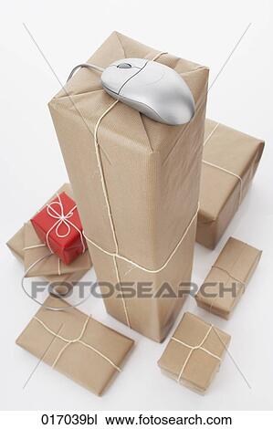 Stock Image - still life of computer mouse and packages. Fotosearch