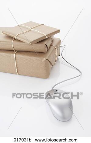 Stock Image - still life of computer mouse and three packages. Fotosearch
