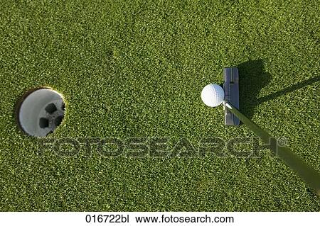 Stock Image - still life of golf hole ball and club. Fotosearch