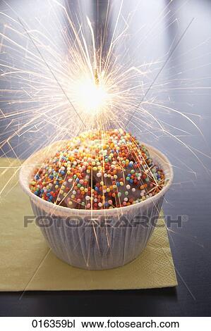 Stock Image - still life of muffin decorated with sparkler. Fotosearch
