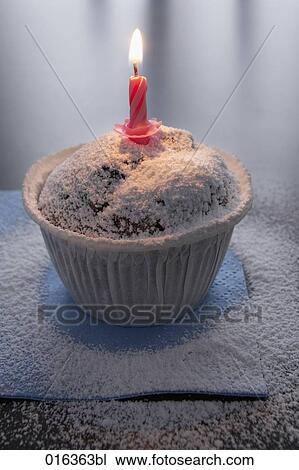 still life of muffin decorated with icing sugar and burning candle View Large Photo Image Stock Image - still life of muffin decorated with icing sugar and burning candle. Fotosearch