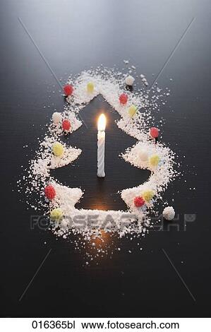 still life of shape of christmas tree made of icing sugar with burning candle View Large Photo Image Stock Image - still life of shape of christmas tree made of icing sugar with burning candle. Fotosearch