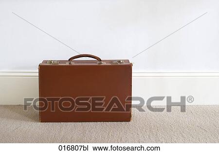 Stock Image - still life of single brown briefcase. Fotosearch