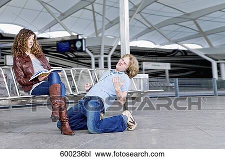 teenage boy playing air guitar in front of girl at underground station View Large Photo Image Stock Image - teenage boy playing air guitar in front of girl at underground station. Fotosearch