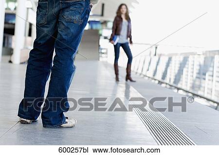 Stock Image - teenage couple meeting at station. Fotosearch