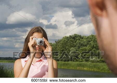 teenage girl taking picture of boyfriend with digital camera View Large Photo Image Stock Image - teenage girl taking picture of boyfriend with digital camera. Fotosearch