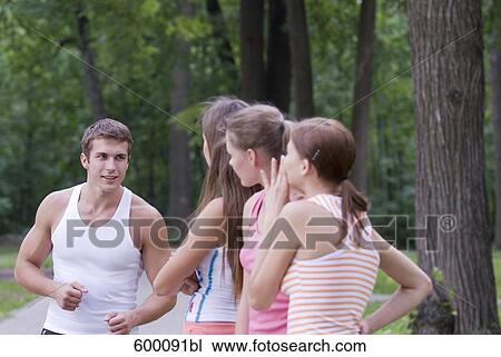 three young woman admiring sporty young man View Large Photo Image Stock Image - three young woman admiring sporty young man. Fotosearch