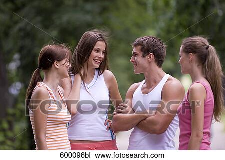 Stock Image - three young woman admiring sporty young man. Fotosearch