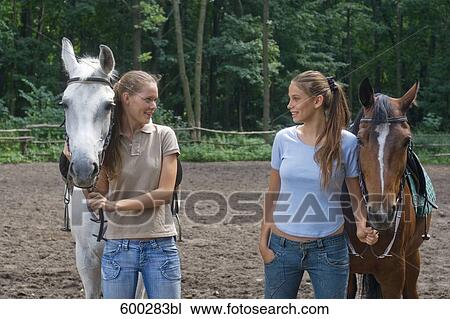 two female friends with horses View Large Photo Image Stock Image - two female friends with horses. Fotosearch