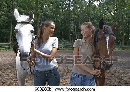 two female friends with horses View Large Photo Image Stock Image - two female friends with horses. Fotosearch