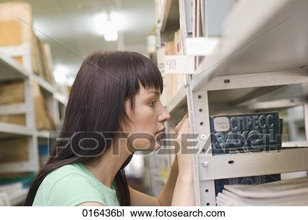 young female student looking for books in school library View Large Photo Image Stock Image - young female student looking for books in school library. Fotosearch