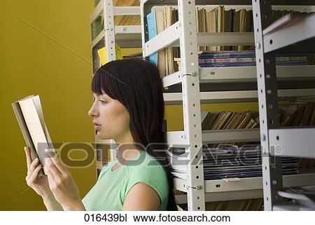 young female student reading textbook in school library View Large Photo Image Stock Image - young female student reading textbook in school library . Fotosearch