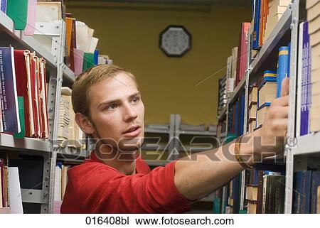 young student in library taking book from shelf View Large Photo Image Stock Image - young student in library taking book from shelf. Fotosearch