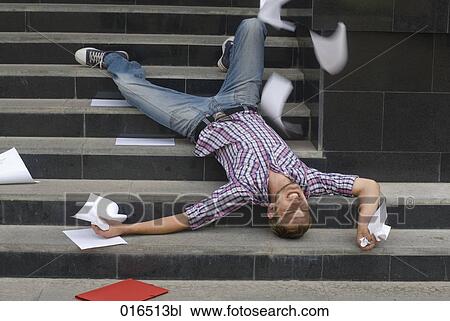 young student lying on his back on stairs surrounded by school documents View Large Photo Image Stock Image - young student lying on his back on stairs surrounded by school documents. Fotosearch