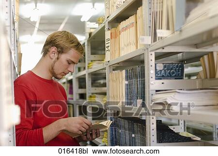 young student reading textbook in school library View Large Photo Image Stock Image - young student reading textbook in school library. Fotosearch