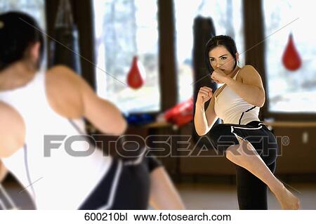 young woman doing kickboxing exercise in front of mirror View Large Photo Image Stock Image - young woman doing kickboxing exercise in front of mirror. Fotosearch