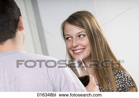 young woman having glass of wine and flirting with man View Large Photo Image Stock Image - young woman having glass of wine and flirting with man. Fotosearch