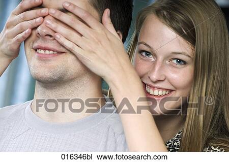 young woman playing peekaboo with boyfriend View Large Photo Image Stock Image - young woman playing peekaboo with boyfriend. Fotosearch