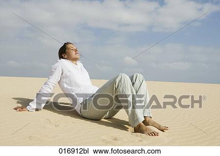young woman relaxing on sandy beach View Large Photo Image Stock Image - young woman relaxing on sandy beach. Fotosearch