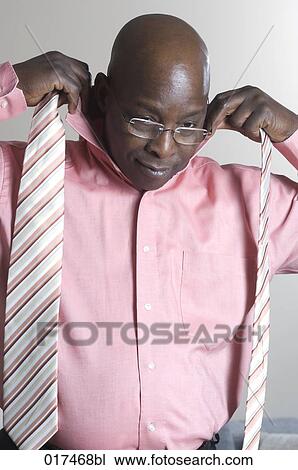 black businessman putting on tie View Large Photo Image Stock Image - black businessman putting on tie. Fotosearch