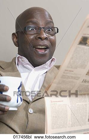 black businessman reading newspaper looking astonished View Large Photo Image Stock Image - black businessman reading newspaper looking astonished . Fotosearch