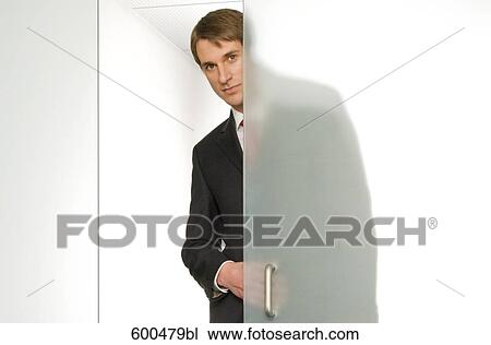 businessman peeking behind half open glass door View Large Photo Image Stock Image - businessman peeking behind half open glass door. Fotosearch