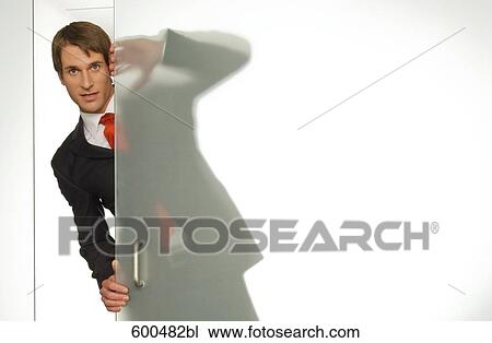 businessman peeking behind half open glass door View Large Photo Image Stock Image - businessman peeking behind half open glass door. Fotosearch