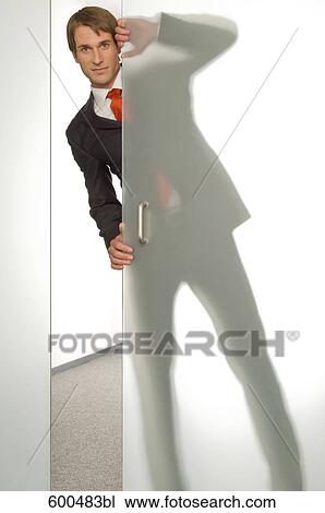 businessman peeking behind half open glass door View Large Photo Image Stock Image - businessman peeking behind half open glass door. Fotosearch