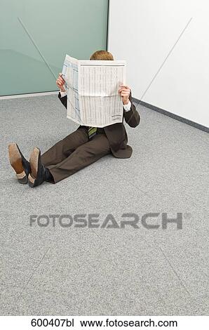 businessman sitting in corner reading newspaper View Large Photo Image Stock Image - businessman sitting in corner reading newspaper. Fotosearch